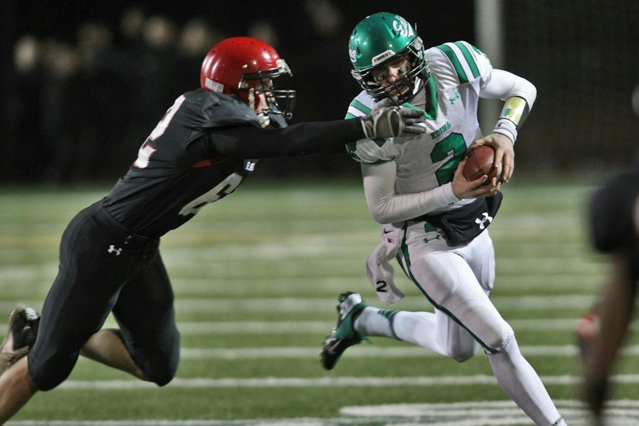 Prep football - Edina Hornets vs. Eden Prairie Eagles. Edina quarterback Mark handberg evaded the tackle of Eden Prairie's Tyler Young for a first half gain. (MARLIN LEVISON/STARTRIBUNE(mlevison@startribune.com