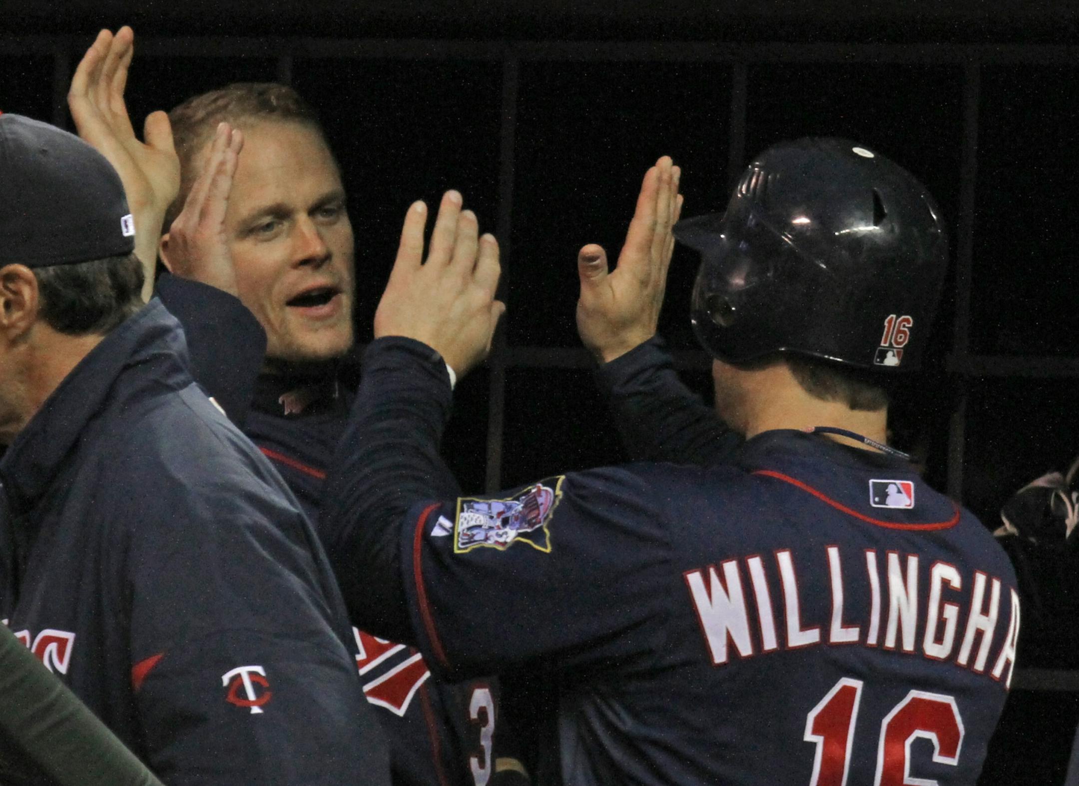 (left to right) Minnesota Twins vs. Texas Rangers, 4/13/12. Twins Justin Morneau celebrated with Josh Willingham after he scored a 2nd inning run on a Danny Valencia hit a rbi.