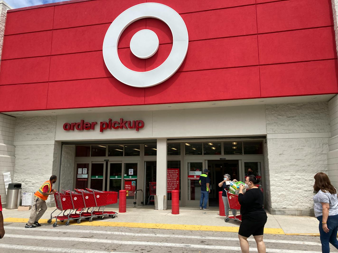 Customers arrive at a Target store, Wednesday, June 2, 2021, in North Miami Beach, Fla. Target says Thursday, Sept. 23, it will hire fewer seasonal workers than last year and instead offer more hours to its current hourly staffers as it navigates a tight labor market. (AP Photo/Wilfredo Lee)