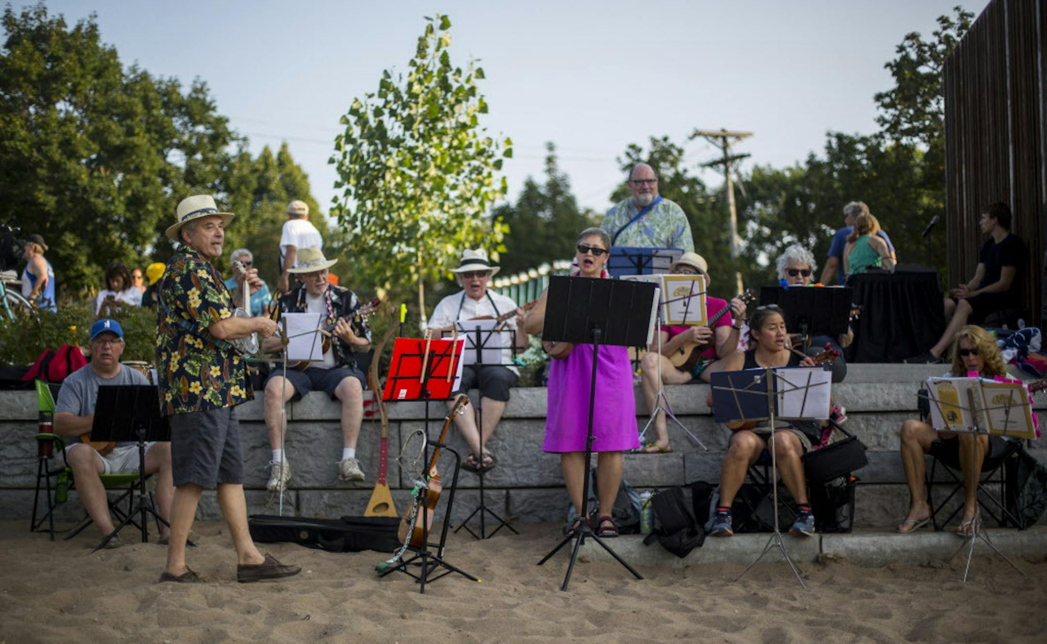 A ukulele group led by Tom Sweeney (far left, front) performed at the grand openeing of Cedar Lake Beach South. ] ALEX KORMANN • alex.kormann@startribune.com The grand opening of Cedar Lake Beach South took place on Monday evening. The event was celebrated with performances by a choir on the beach featuring "Blue Lady" as well as a ukulele group led by Tom Sweeney. Beach goers enjoyed swimming and sunbathing while they listened to the music.