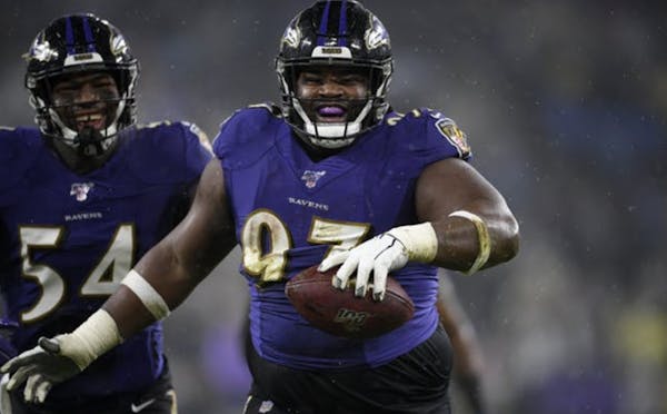 Ravens defensive tackle Michael Pierce celebrates his fumble recovery with linebacker Tyus Bowser during a game against the Steelers on Dec. 29