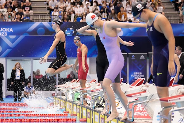Regan Smith of the U.S., left, and other swimmers prepare to compete during the women’s 4x100m medley relay final at the World Swimming Championship