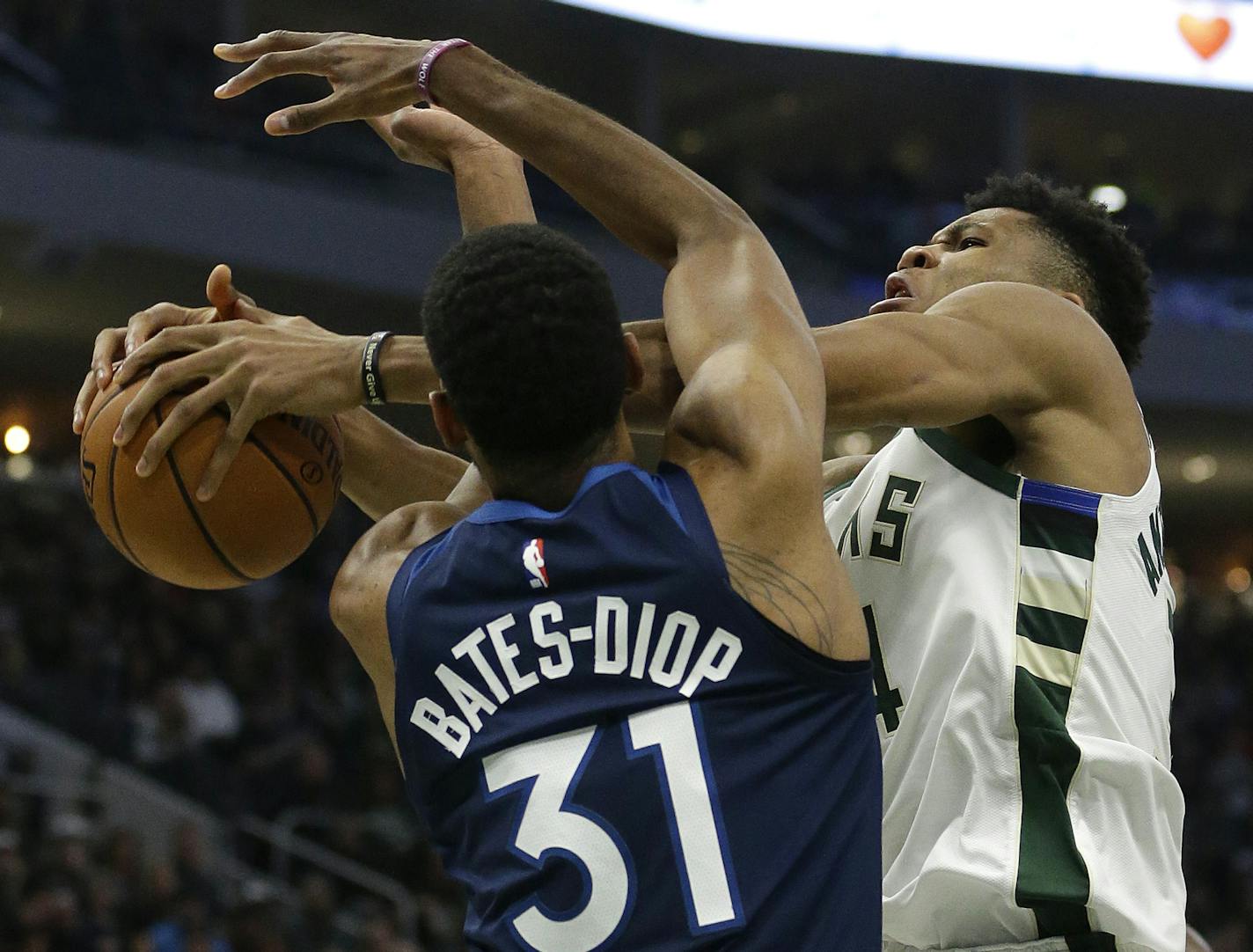 Milwaukee Bucks' Giannis Antetokounmpo, right, is fouled by Minnesota Timberwolves' Keita Bates-Diop (31) during the second half of an NBA basketball game Saturday, Feb. 23, 2019, in Milwaukee. (AP Photo/Aaron Gash)