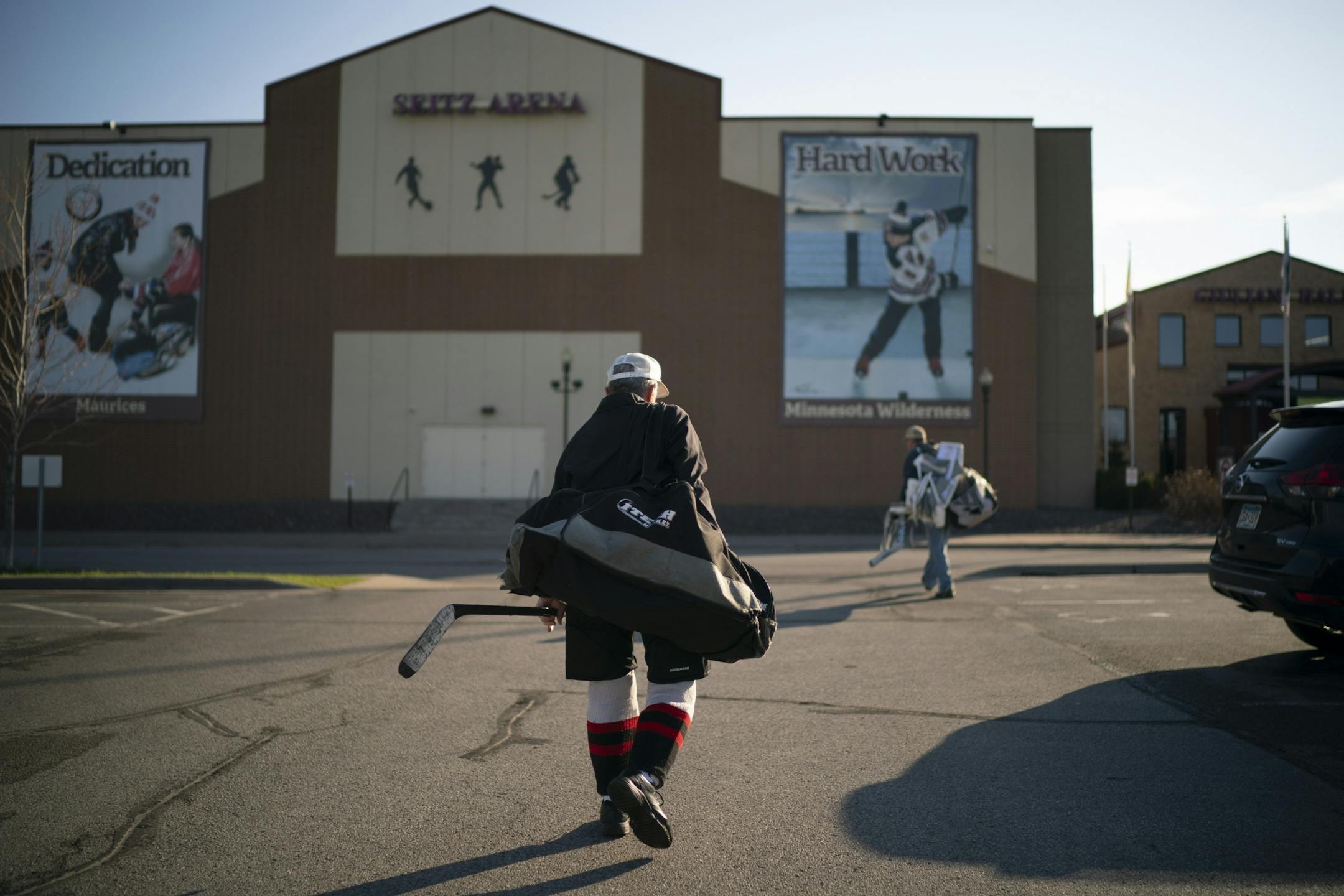 Mark Sertich walked with his gear towards the Essentia Duluth Heritage Center for a morning hockey game Thursday.