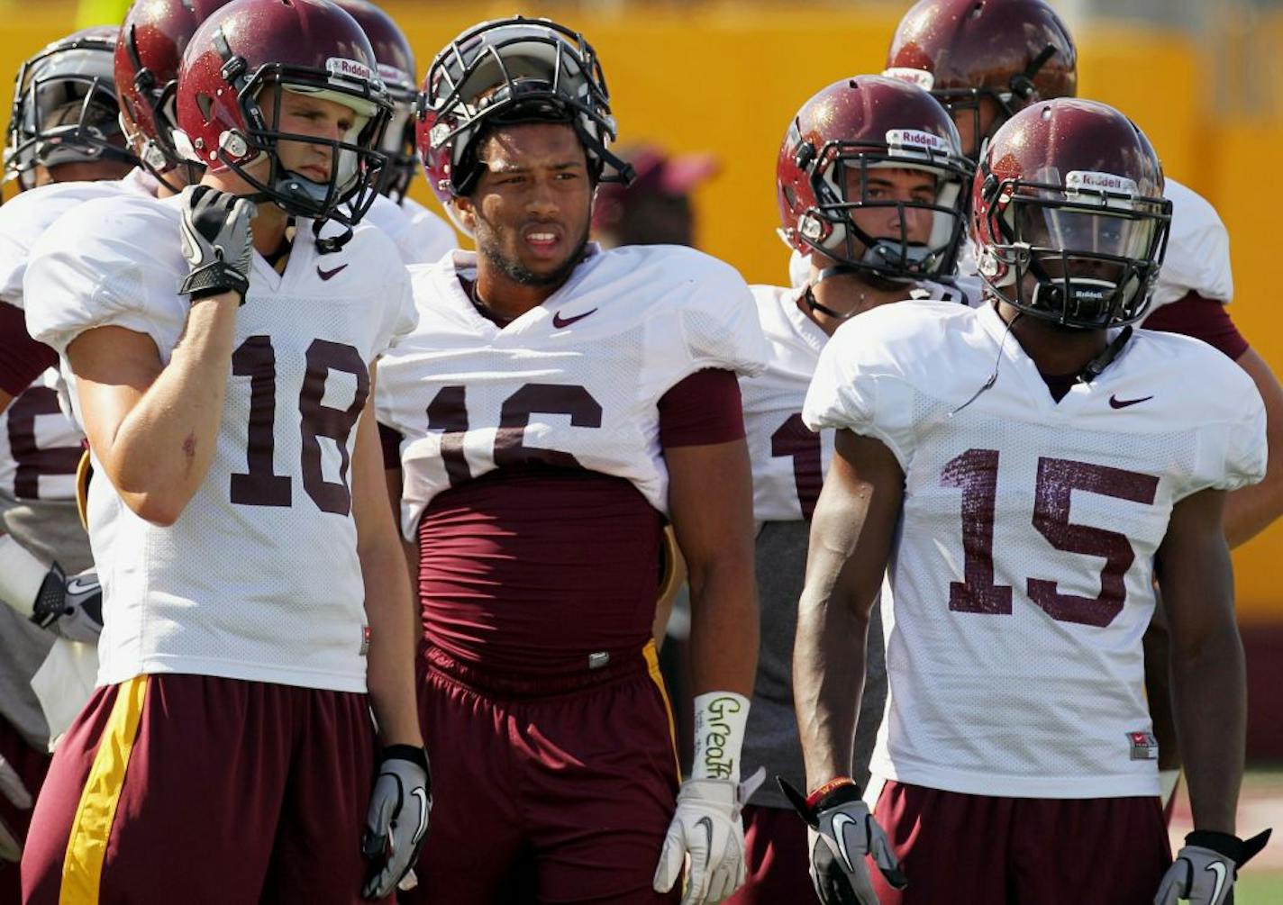 Minnesota wide receivers, from left to right, Derrick Engel (18), Jamel Harbison (16), C.J. Cesario and Marcus Jones (15 attend NCAA college football practice on Thursday, Aug. 9, 2012, in Minneapolis.