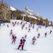 In this hand out image provided by Crested Butte Mountain Resort, shows participants dressed as Santas skiing from Uley's Ice Bar on Crested Butte Mou