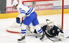 Chanhassen goaltender Kam Hendrickson blocked a shot by Minnetonka forward Hagen Burrows in the first period Thursday, one of Hendrickson's 43 saves.