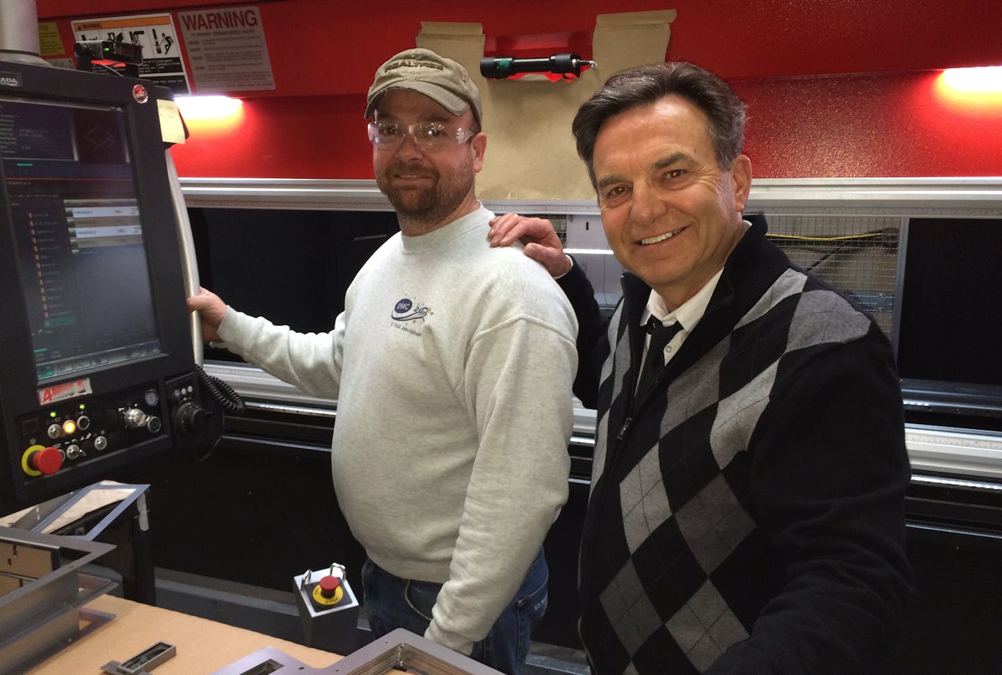 Press brake operator/programmer Dave Kuehl and CEO Bob Du Fresne on the factory floor at Du Fresne Manufacturing in Vadnais Heights