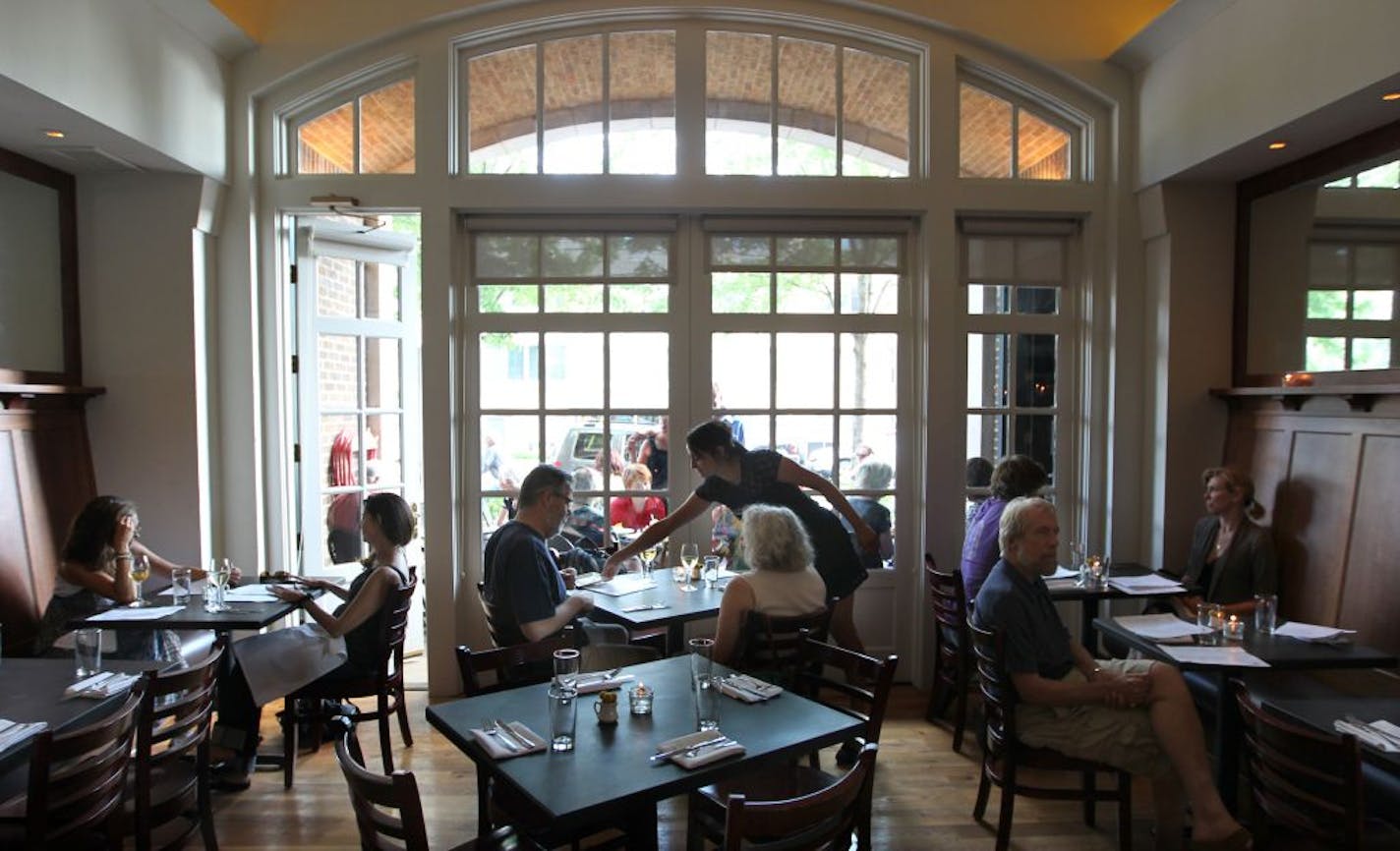 The Main dining room. ___Restaurant review of Harriet Brasserie, Portraits of owner Alain Lenne and chef Fernando Silvo, Food: Scallops and sausage, Wasabi Marlin, Bison Tartare, Chilled Pea Soup, Sweet Corn Sccotash. Surroundings: It's a small and very charming place set in the old fire house of Linden Hills. [ TOM WALLACE � twallace@startribune.com _ Assignments #20023987A_ June 20, 2012_ SLUG: rn0628_ EXTRA INFORMATION: CQ'ed by owners