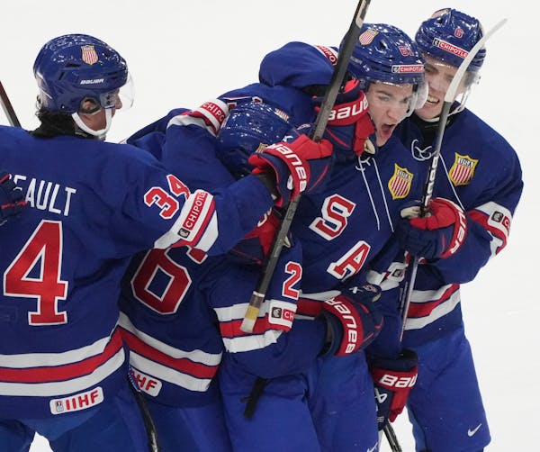 Team USA winger Jimmy Snuggerud, second from right, was mobbed after scoring a goal against Finland in the world junior hockey tournament Thursday in 
