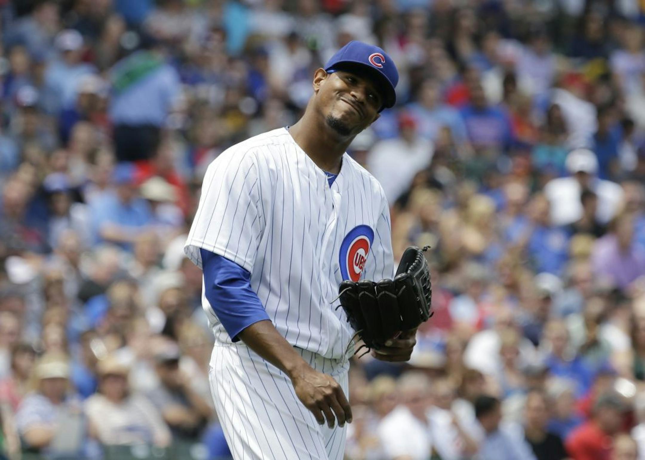 Chicago Cubs starter Edwin Jackson reacts after Pittsburgh Pirates' Starling Marte hit a single during the third inning of a baseball game, Sunday, June 9, 2013, in Chicago.