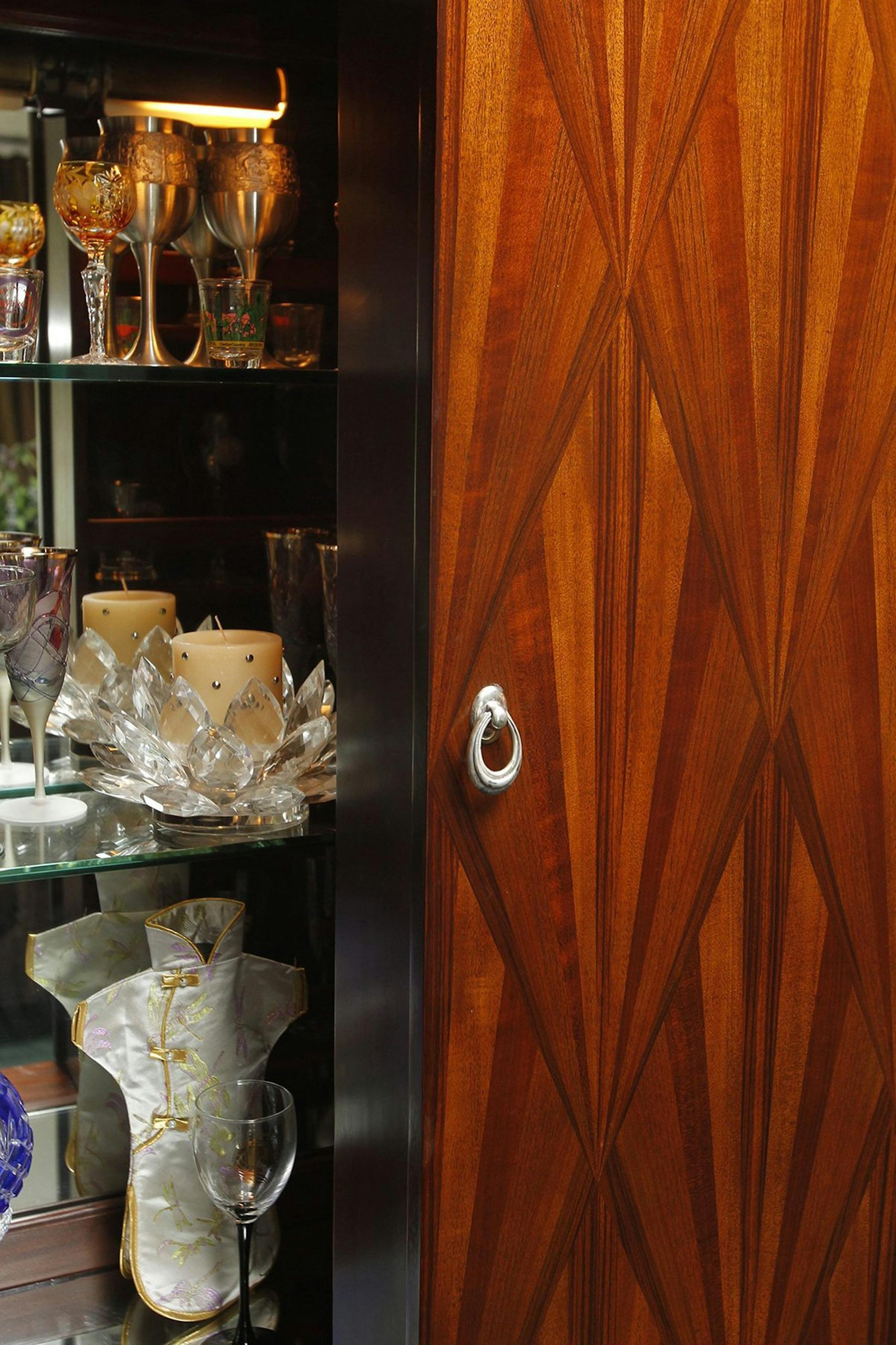 The glass collection of Allison Perley-Harter is displayed in this 1940's retro liquor cabinet in Hudson, Ohio, on Oct. 26, 2013. (Karen Schiely/Akron Beacon Journal/MCT)