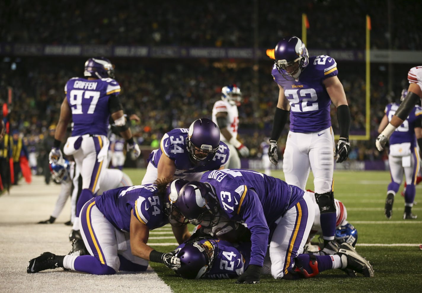 Vikings cornerback Captain Munnerlyn (24) was congratulated by his teammates after he intercepted a pass in the third quarter and returned it 32 yards to the Giants 4-yard line Sunday night.