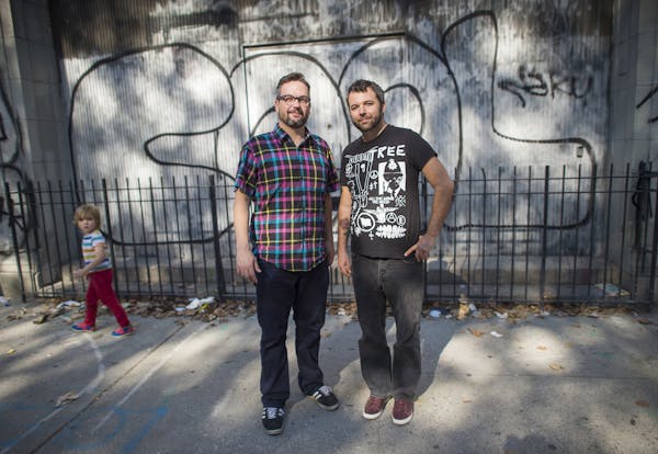 "Welcome to Night Vale" creators Jeffrey Cranor, left, and Joseph Fink pose on the street in Manhattan's East Village where they first connected.
