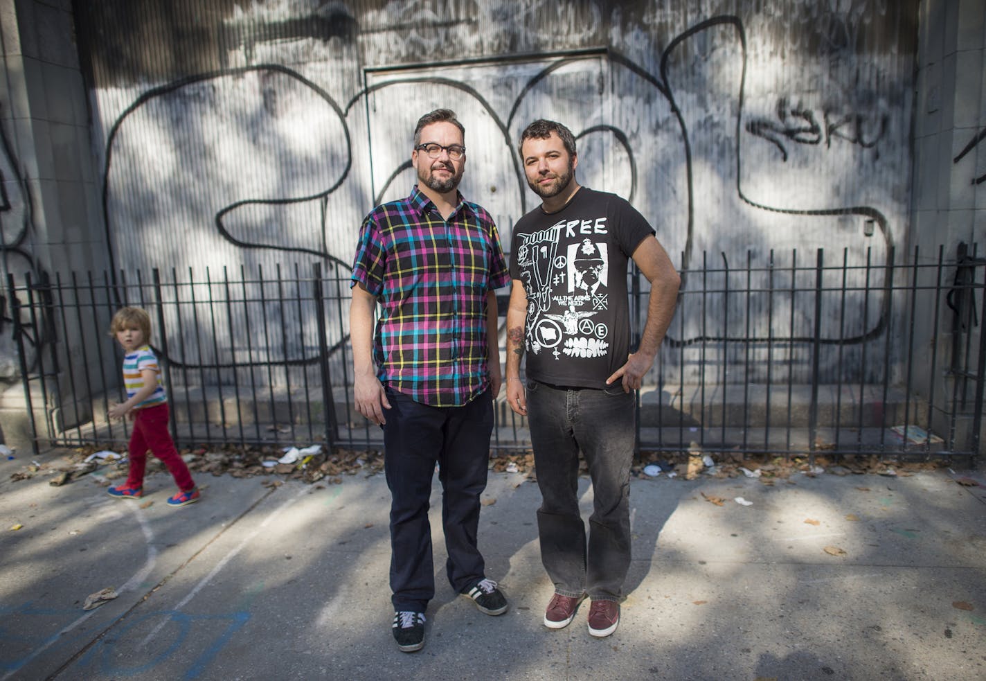 "Welcome to Night Vale" creators Jeffrey Cranor, left, and Joseph Fink pose on the street in Manhattan's East Village where they first connected.