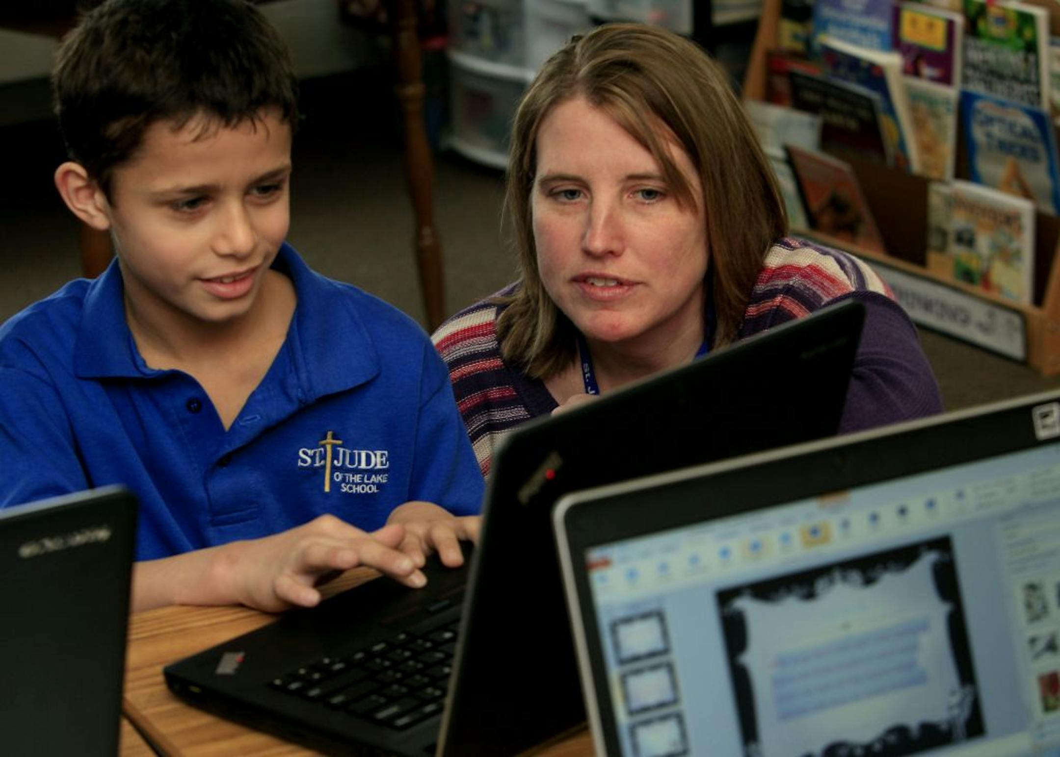 Third grade teacher Lynette Loch of St. Jude of the Lake school in Mahtomedi, MN works with 3rd grade studentLeo Gruba on his power point presentation. Mahtomedi, MN January 16, 2013.