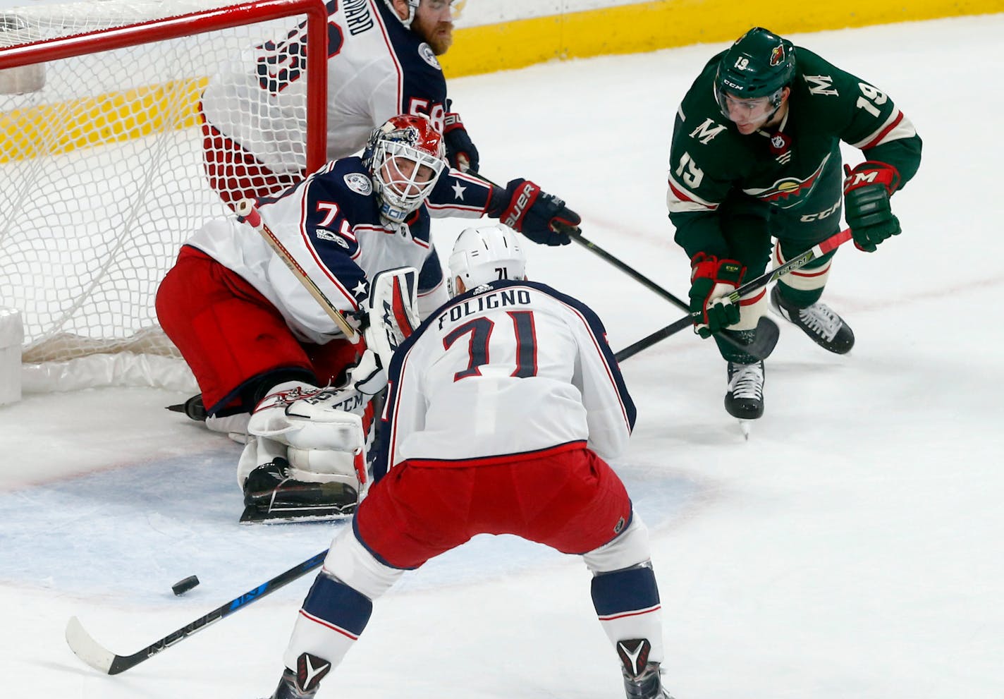 Columbus Blue Jackets goalie Sergei Bobrovsky, left, of Russia, stops a shot as Minnesota Wild's Luke Kunin, right, looked for a rebound during the first period