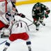 Columbus Blue Jackets goalie Sergei Bobrovsky, left, of Russia, stops a shot as Minnesota Wild's Luke Kunin, right, looked for a rebound during the fi