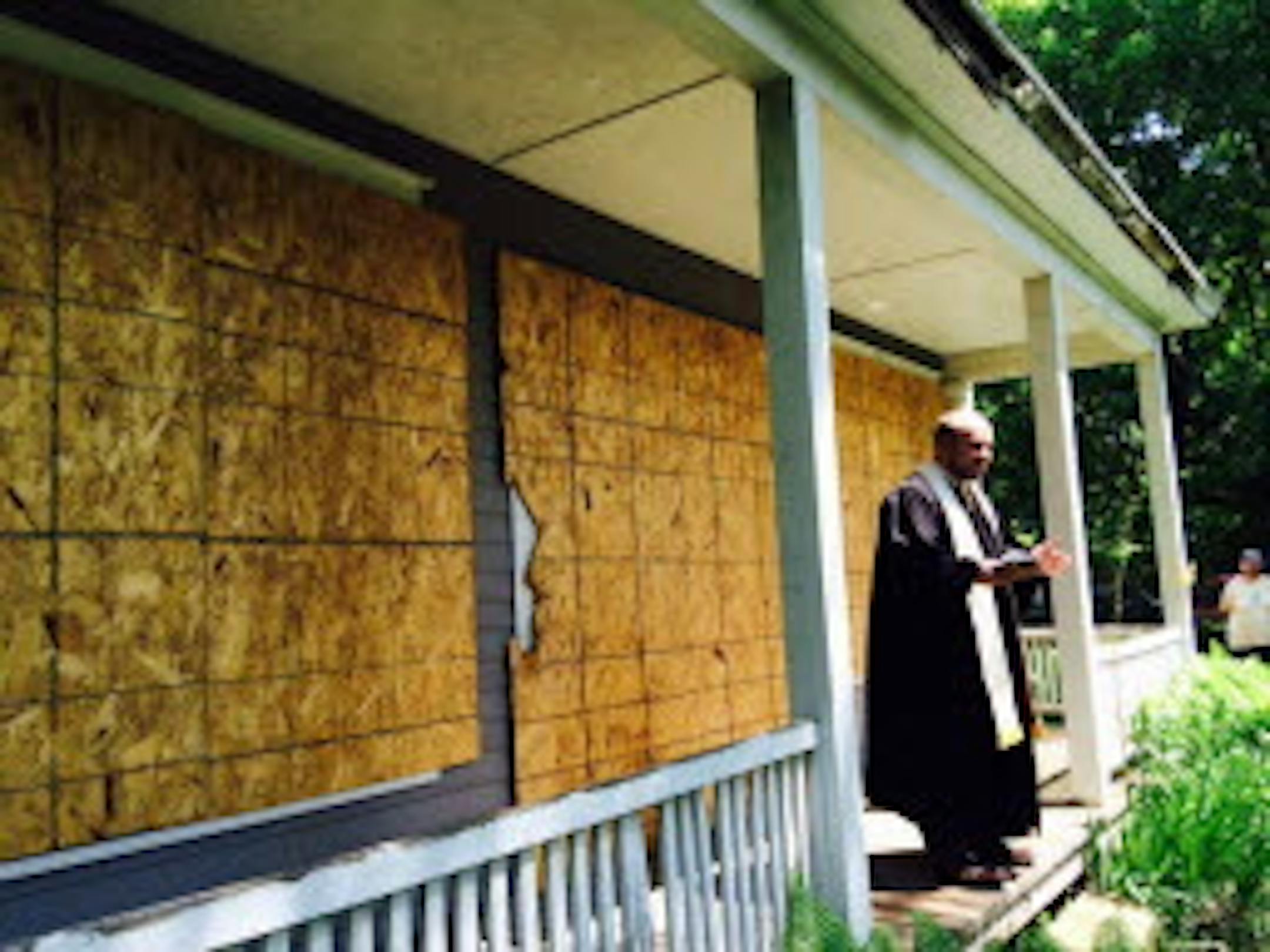 The Rev. Cader Howard of the First Presbyterian Church of Stillwater blessed the Boutwell House in 2015. He held one of the Rev. William Boutwell's original bibles, from the Washington County Historical Society collection.