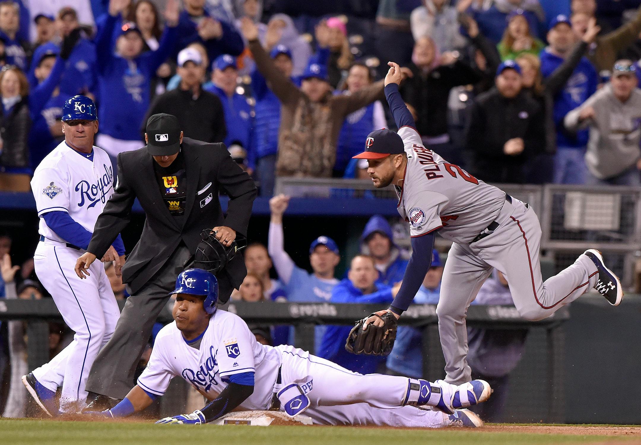 The Kansas City Royals' Salvador Perez slides into third with an RBI triple before the tag from Minnesota Twins third baseman Trevor Plouffe, right, in the eighth inning on Friday, April 8, 2016, at Kauffman Stadium in Kansas City, Mo. (John Sleezer/Kansas City Star/TNS) ORG XMIT: 1183139