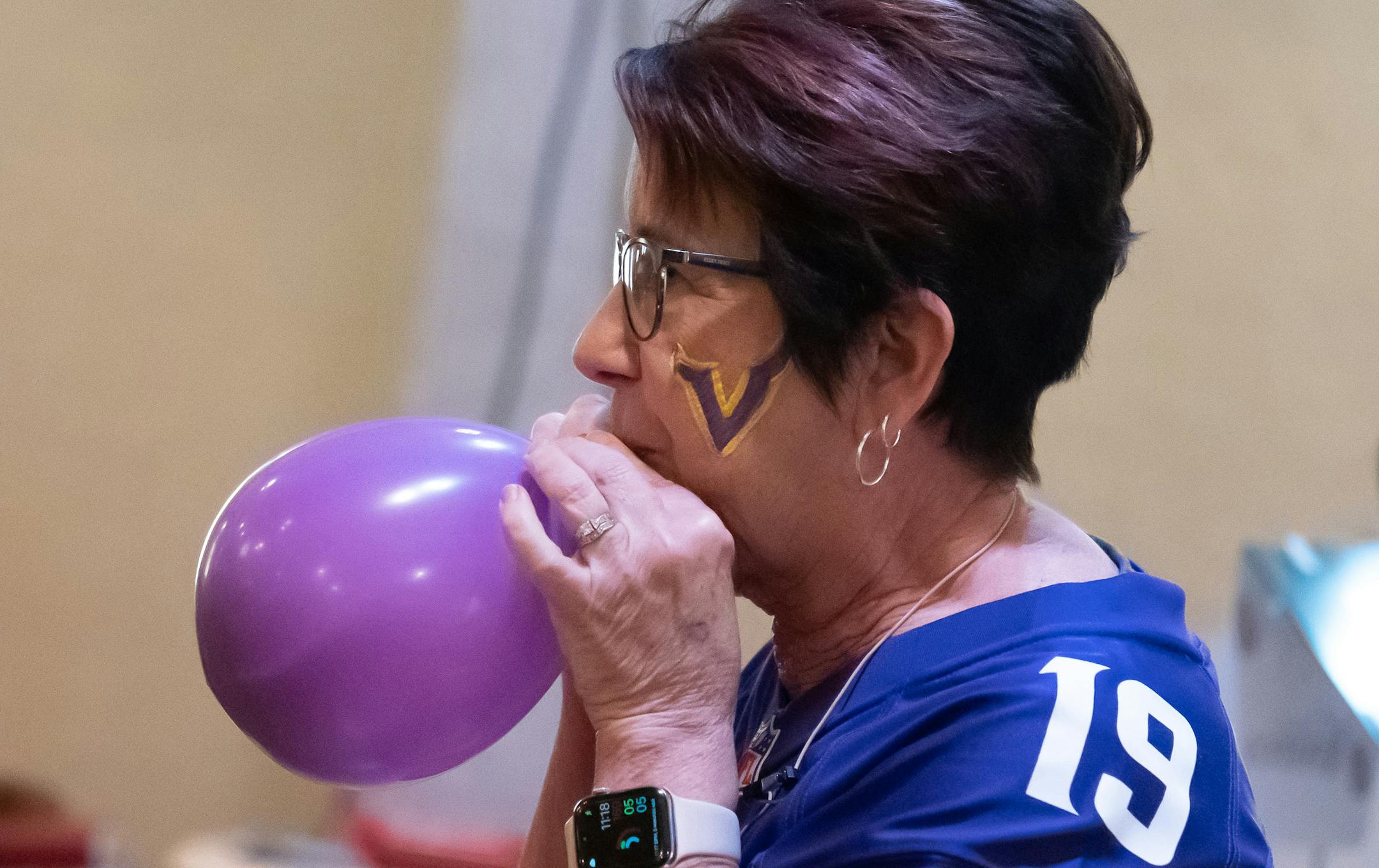 Pastor Vicki VanderVegt inflated a purple Vikings balloon toward the end of the service.
