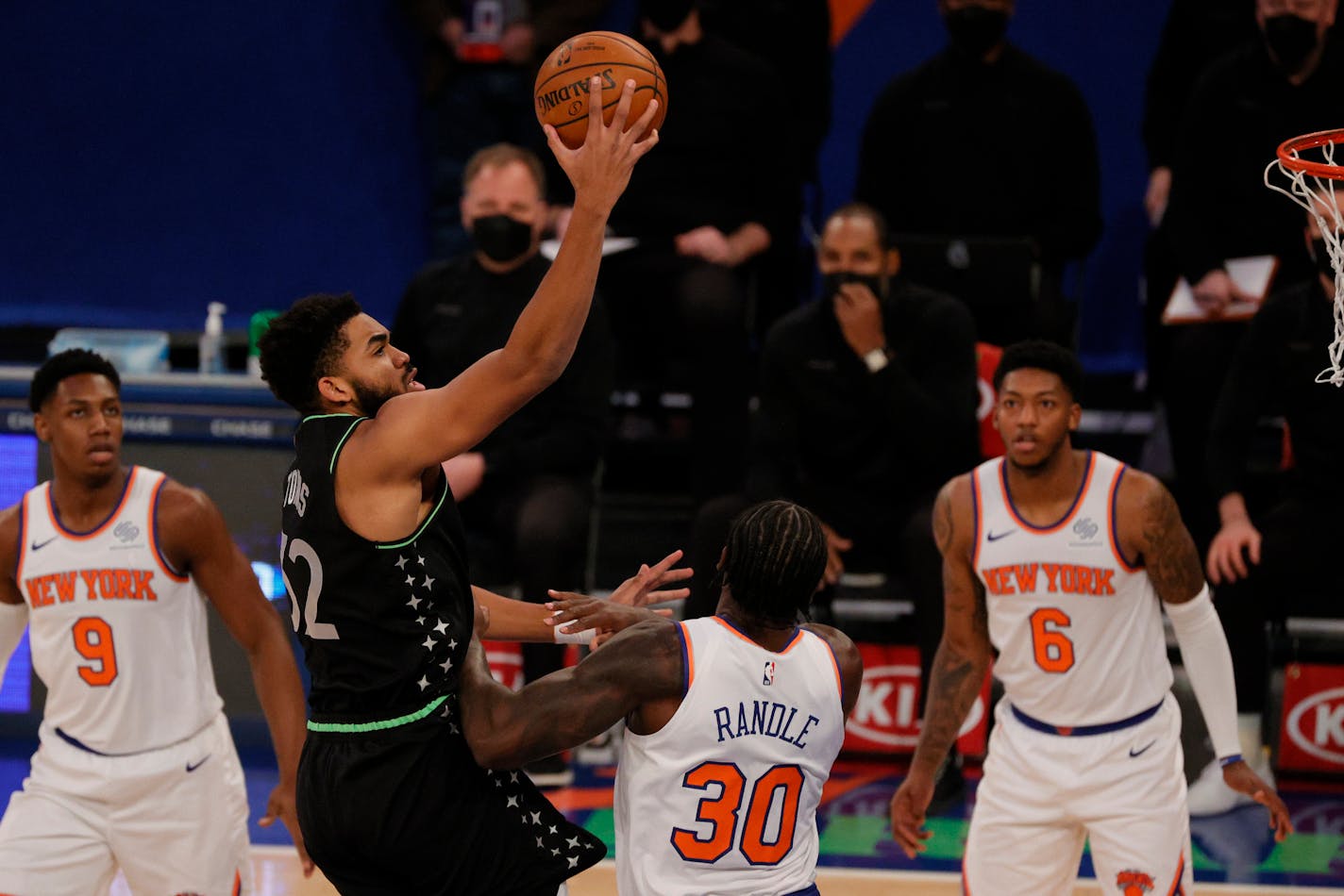 Minnesota Timberwolves' Karl-Anthony Towns (32) shoots as New York Knicks' RJ Barrett (9), Julius Randle (30) and Elfrid Payton (6) defend during the first half of an NBA basketball game Sunday, Feb. 21, 2021, in New York. (Sarah Stier/Pool Photo via AP)