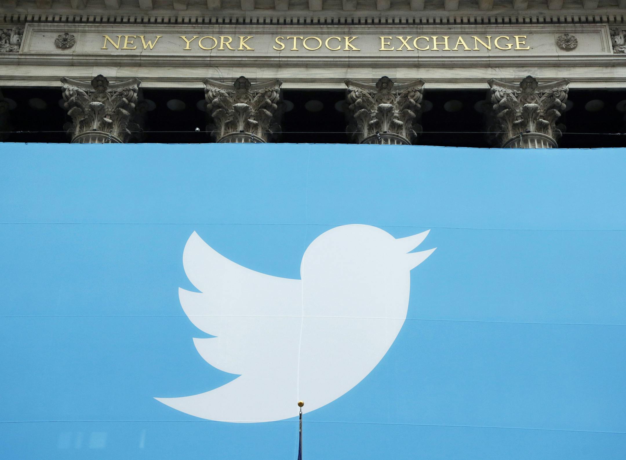 File - In this Nov. 7, 2013, file photo, a Twitter sign is draped on the facade of the New York Stock Exchange before its IPO in New York. Twitter reports quarterly financial results on Tuesday, July 28, 2015. (AP Photo/Mark Lennihan, File)