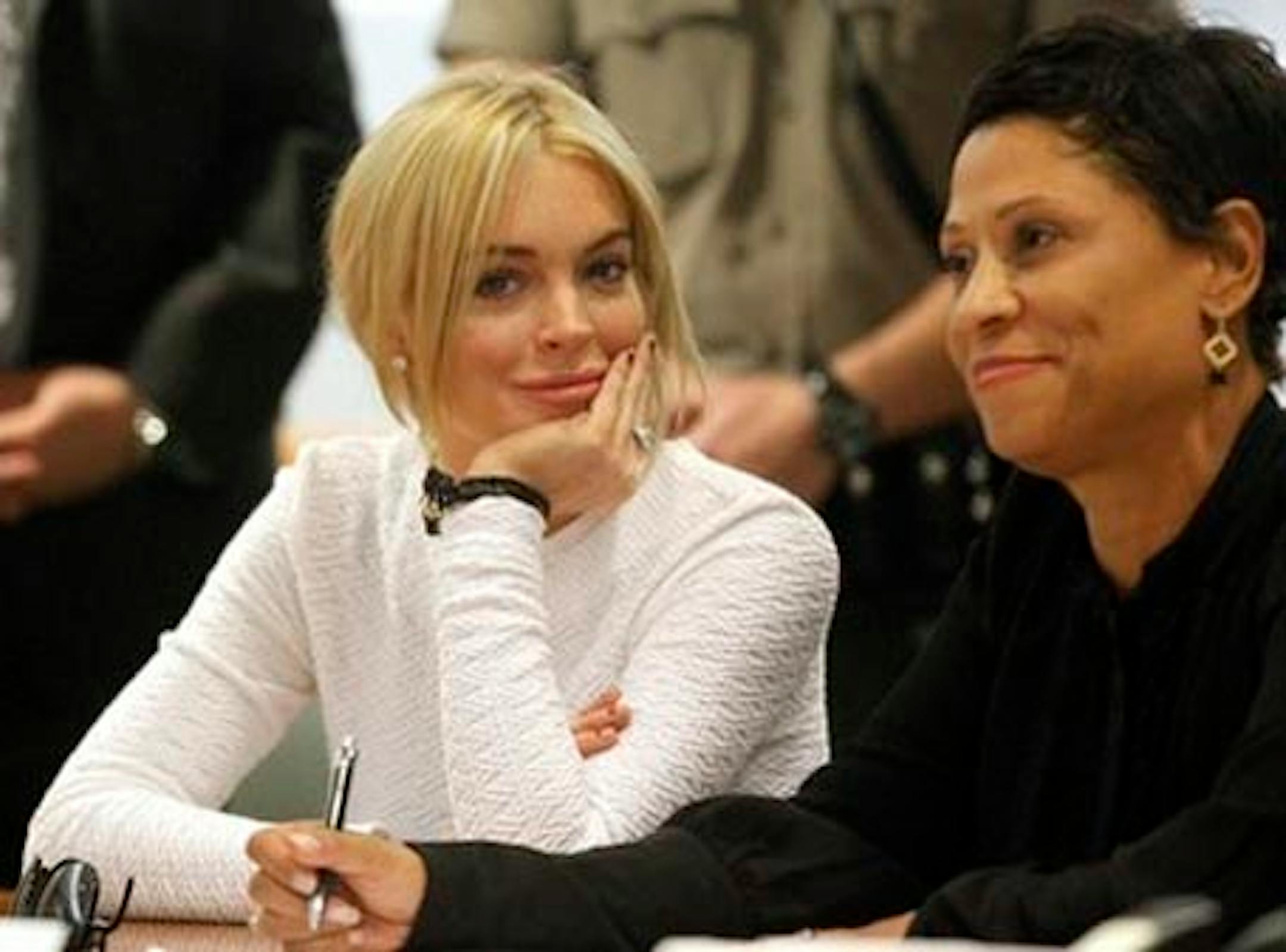 Actress Lindsay Lohan, left, appears in court during her arraignment on a felony grand theft charge with her lawyer Shawn Chapman Holley at the LAX Airport Courthouse in Los Angeles, Wednesday, Feb. 9, 2011. (AP Photo/Mario Anzuoni, Pool)