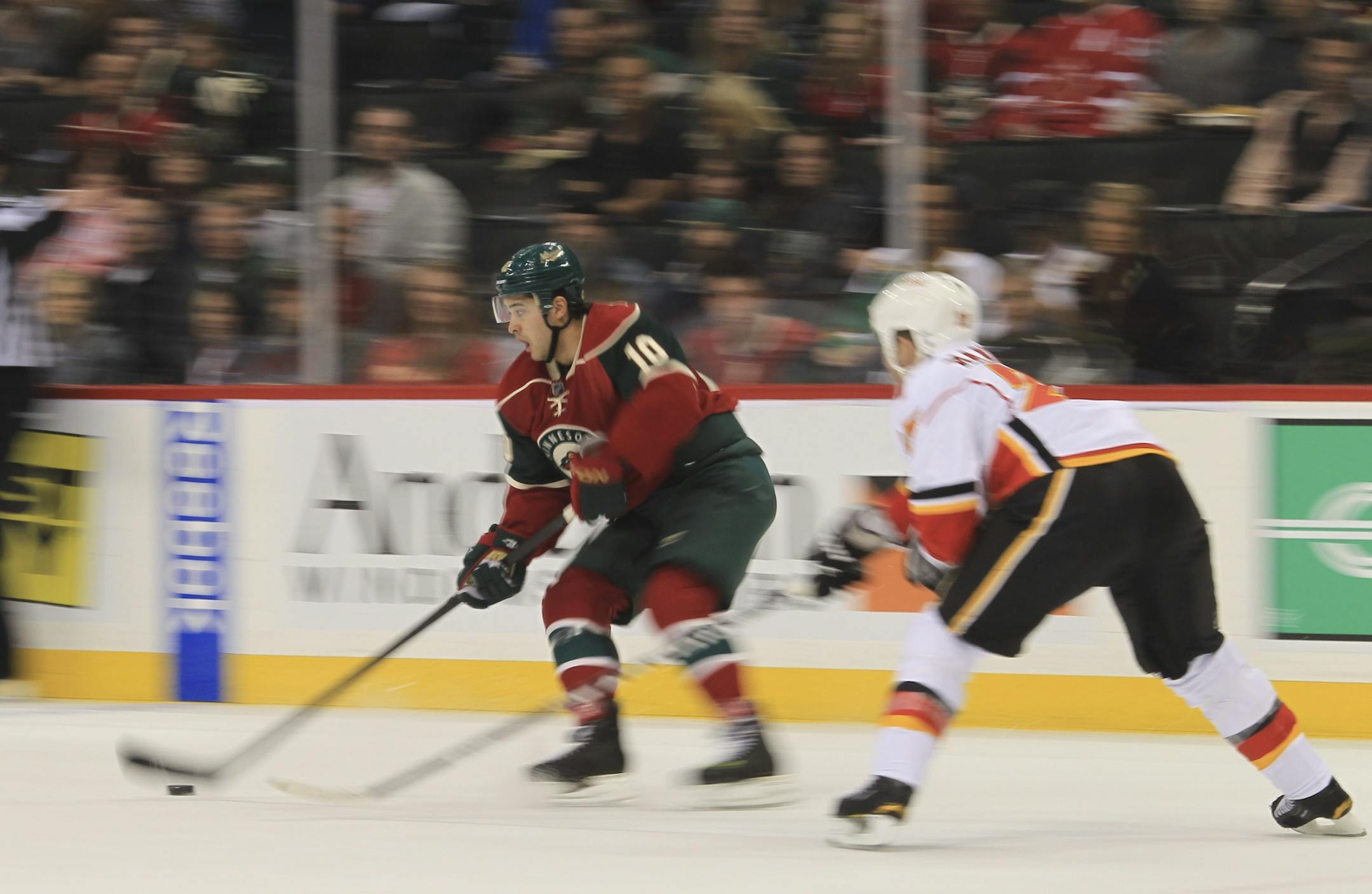 The Wild's Devin Setoguchi controlled the puck against the Flames' Scott Hannan.