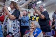 Carolyn Cavender Schommer, center, along with other tribal members, witnesses the signing of documents that officially marks the return of the state-o