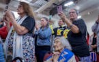Carolyn Cavender Schommer, center, was among tribal members witnessing the signing of documents that marks the return of state-owned land within Upper
