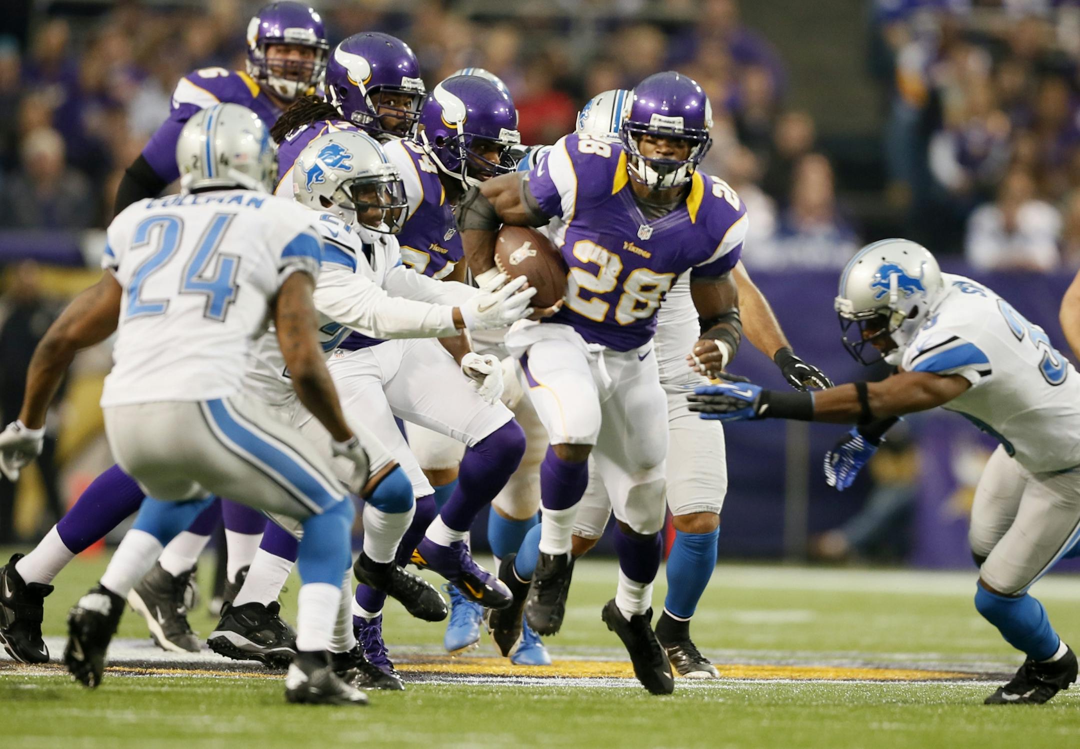 Adrian Peterson (28) burst up the middle for a first down Sunday.