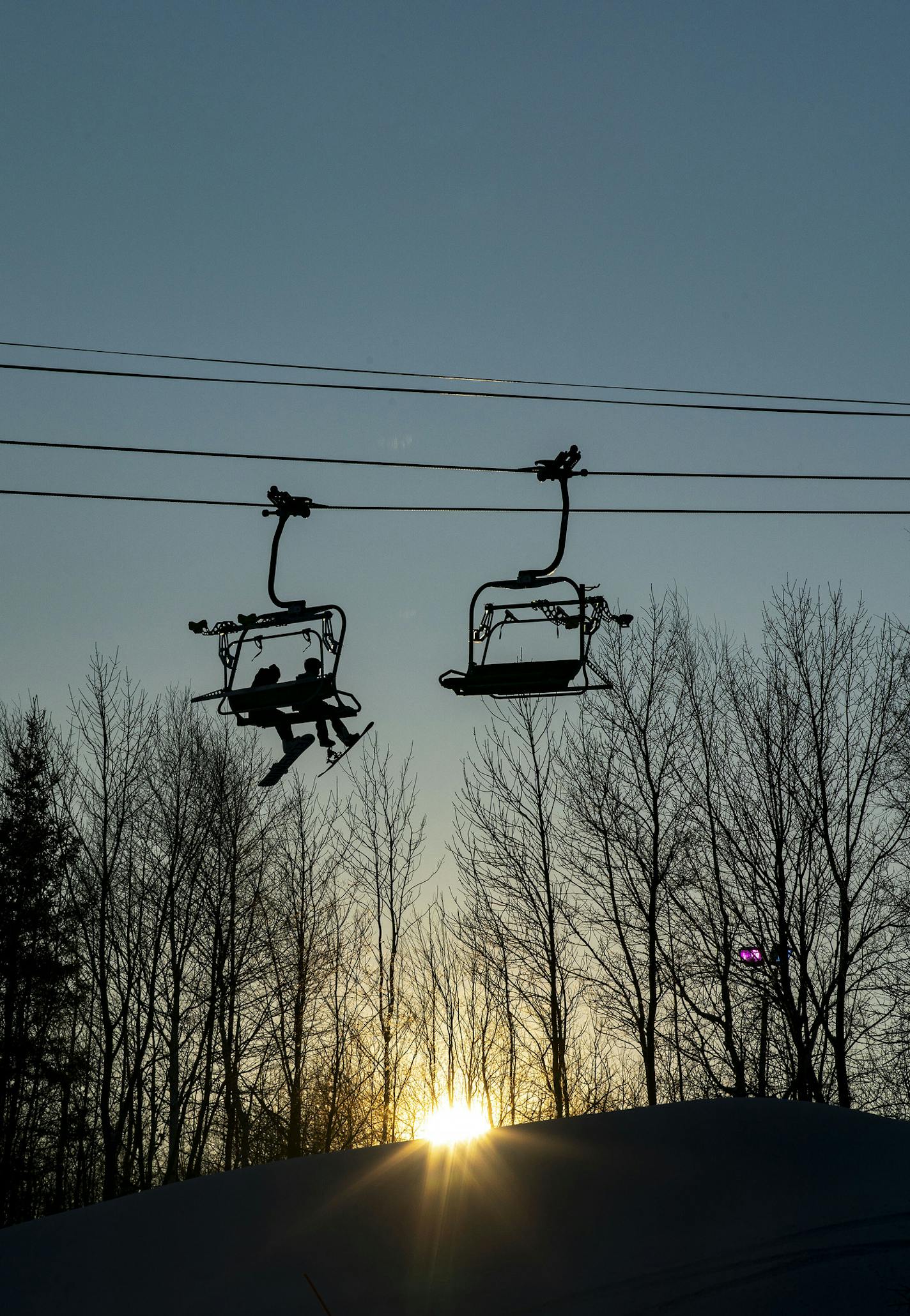 Two snowboarders rode one of the ski lifts up Duluth's Spirit Mountain on Tuesday. ORG XMIT: MIN1912171728438924