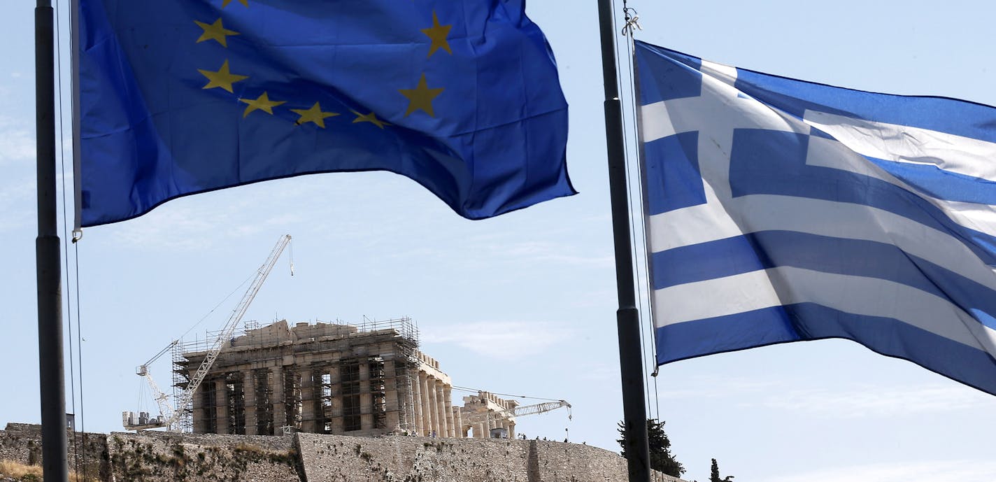 A Greek and a European Union flag billow in the wind as the ruins of the fifth century BC Parthenon temple are seen in the background on the Acropolis hill, Athens, Wednesday, June 3, 2015. Greece's prime minister was heading to high-level meetings in Brussels on Wednesday to try to persuade the country's creditors to accept a proposal that might unlock much-delayed bailout loans and save the country from financial disaster. (AP Photo/Petros Giannakouris) ORG XMIT: MIN2015062411223253