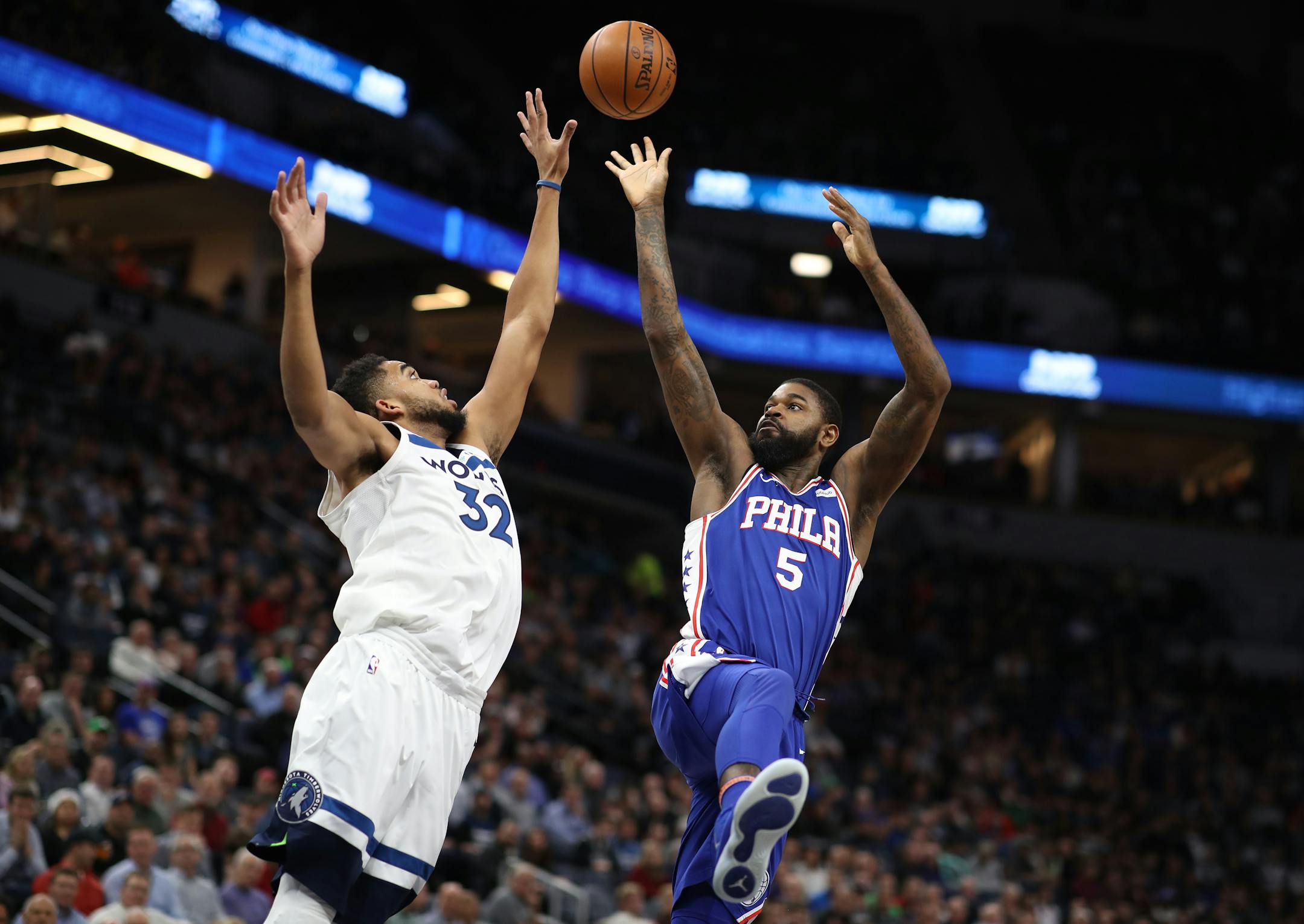 Philadelphia 76ers forward Amir Johnson (5) shot a jumper of Minnesota Timberwolves center Karl-Anthony Towns (32).