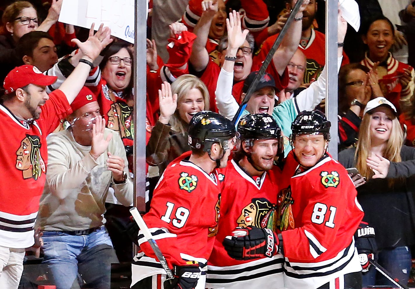 Jonathan Toews (19), Brandon Saad (20) and Marian Hossa (81) celebrated a goal by Saad in the first period of Game 1 against the Wild.