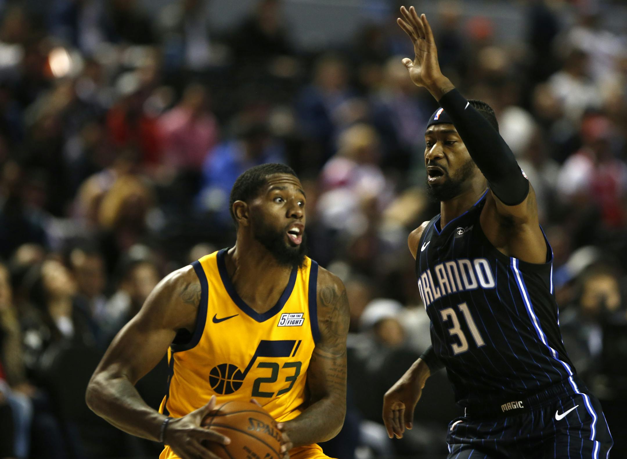 Utah Jazz's Royce O'Neale, left, drives around Orlando Magic's Terrence Ross in a regular-season NBA basketball game in Mexico City, Saturday Dec.15, 2018. (AP Photo/Claudio Cruz)