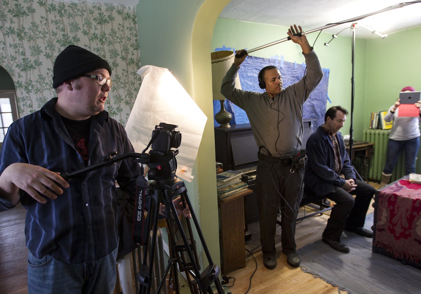 Left to right, writer and director Matthew G. Anderson, sound and light technician Mickey Richardson, and actor Mark L. Mattison prepare to run a scene as Theater People films a web episode in a farm house in Minnetrista January 17, 2015. (Courtney Perry/Special to the Star Tribune)