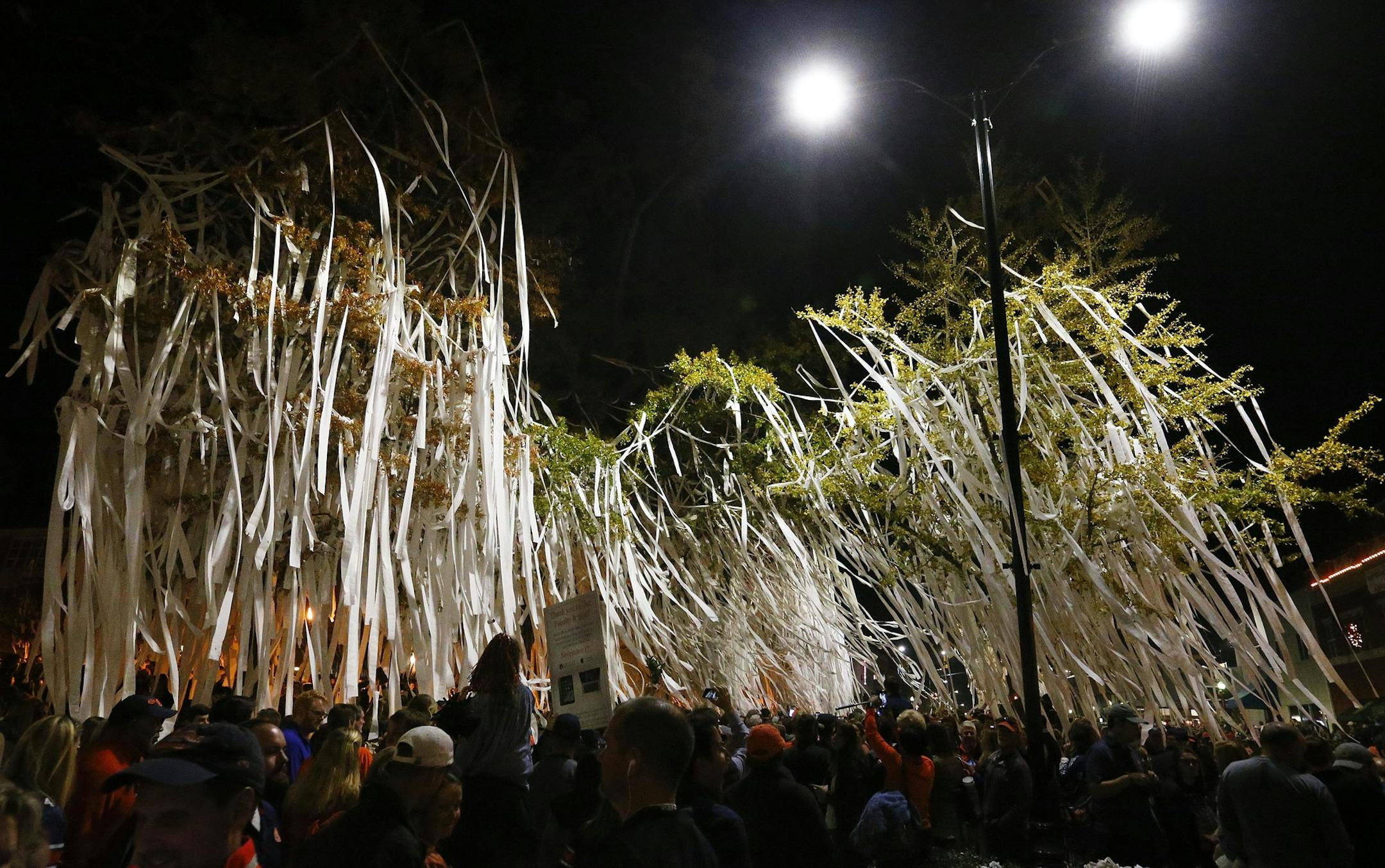 Toomer's corner trees are rolled in celebrations after the Iron Bowl NCAA football game against Alabama, Saturday, Nov. 25, 2017, in Auburn, Ala. Auburn won 26-14. (AP Photo/Butch Dill)