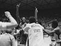 Michigan State's Earvin 'Magic' Johnson raises his hand after they defeated Larry Bird and Indiana State 75-64 to win the NCAA championship, in Salt L