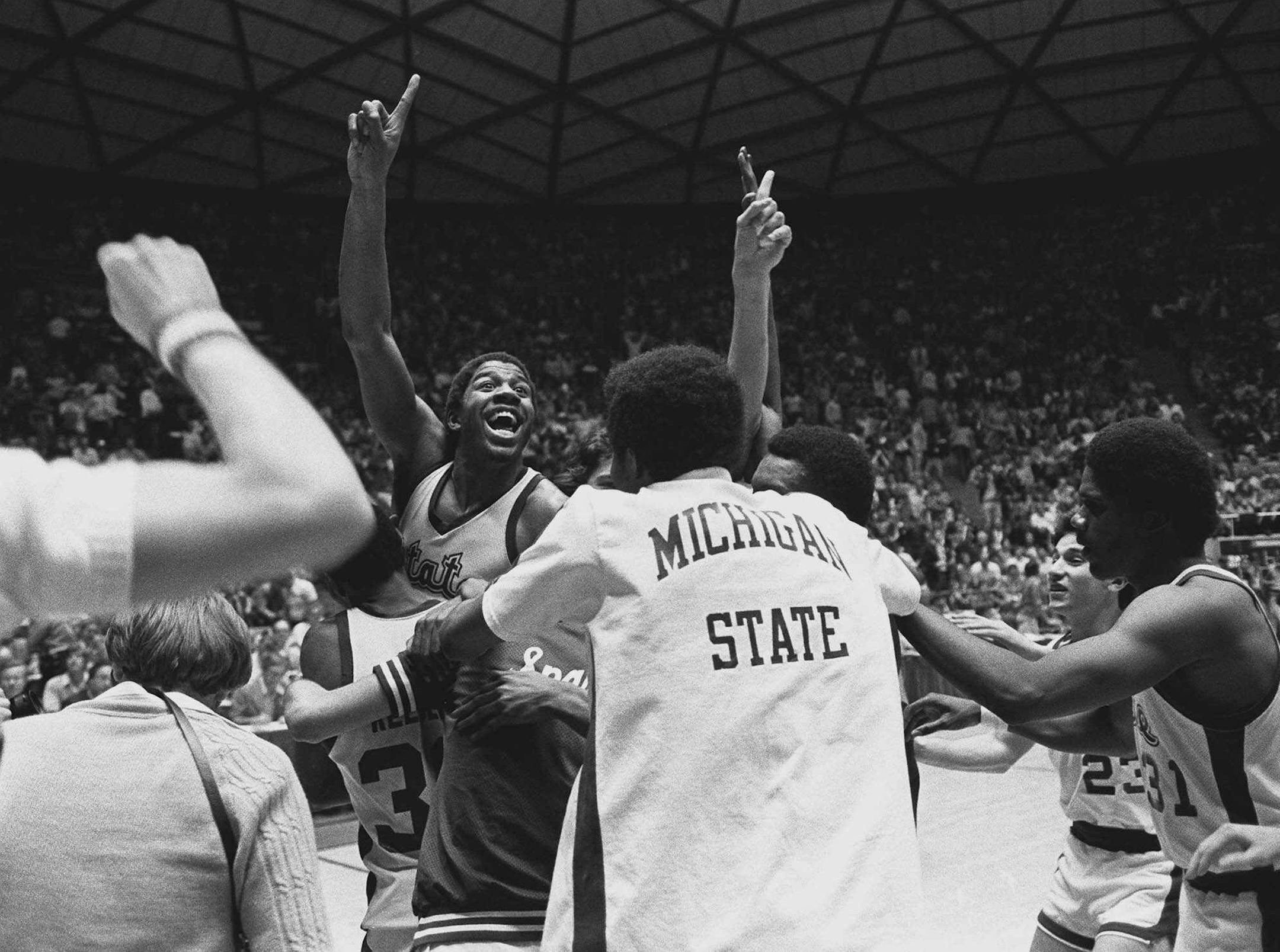 Michigan State's Earvin 'Magic' Johnson raises his hand after they defeated Larry Bird and Indiana State 75-64 to win the NCAA championship, in Salt Lake City