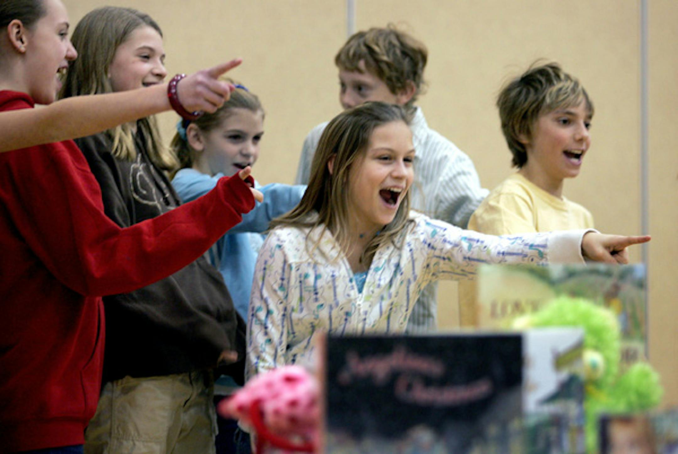 Century Middle School sixth-graders, from left, Melina Anderson, Cassie Tomberlin, Sami Peick, Taylor Lees, Reed Ziehr and Jason Windhorn, all members of the Leadership Team, encouraged classmates to participate in a May 3 school garage sale during a school assembly.