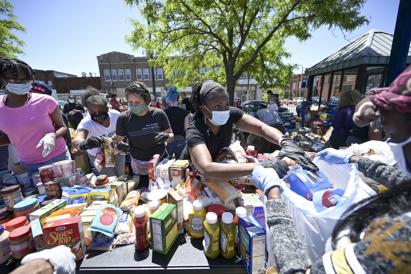 Cathy Burns, an employee with the city of Minneapolis, handed out food items while volunteering in north Minneapolis on May 30.