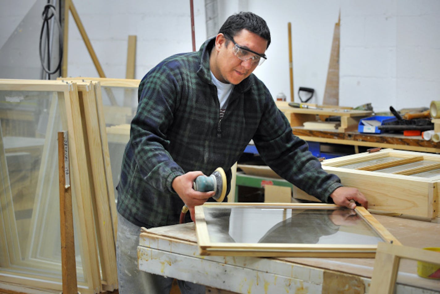 Jeff Pederson worked on a custom-built double-hung insulated window on Monday at A&A Millwork in Minneapolis.