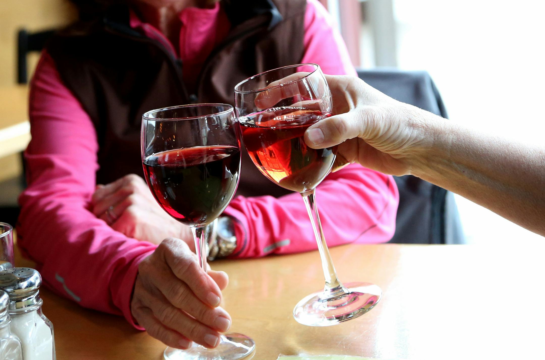Katie Fisher and Isabel Keating click their glasses of wine at Beaujo's after enjoying a movie. ] (KYNDELL HARKNESS/STAR TRIBUNE) kyndell.harkness@startribune.com At Beaujo's in Minneapolis, Min., Thursday, February 19, 2015.