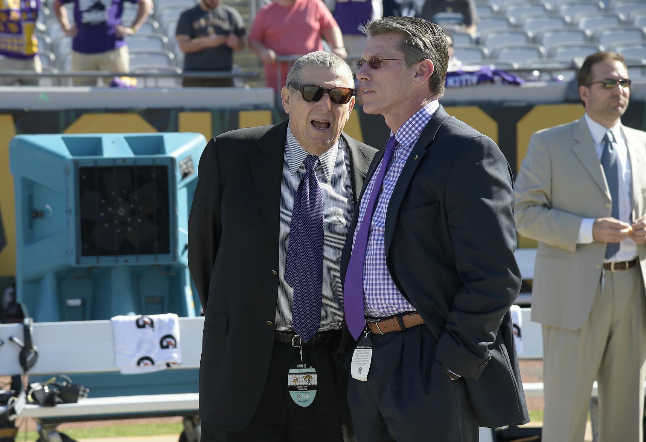 Minnesota Vikings owner Leonard Wilf, left, and general manager Rick Spielman chat on the sideline before an NFL football game against the Jacksonville Jaguars in Jacksonville, Fla., Sunday, Dec. 11, 2016. (AP Photo/Phelan M. Ebenhack) ORG XMIT: MIN2017012114565144