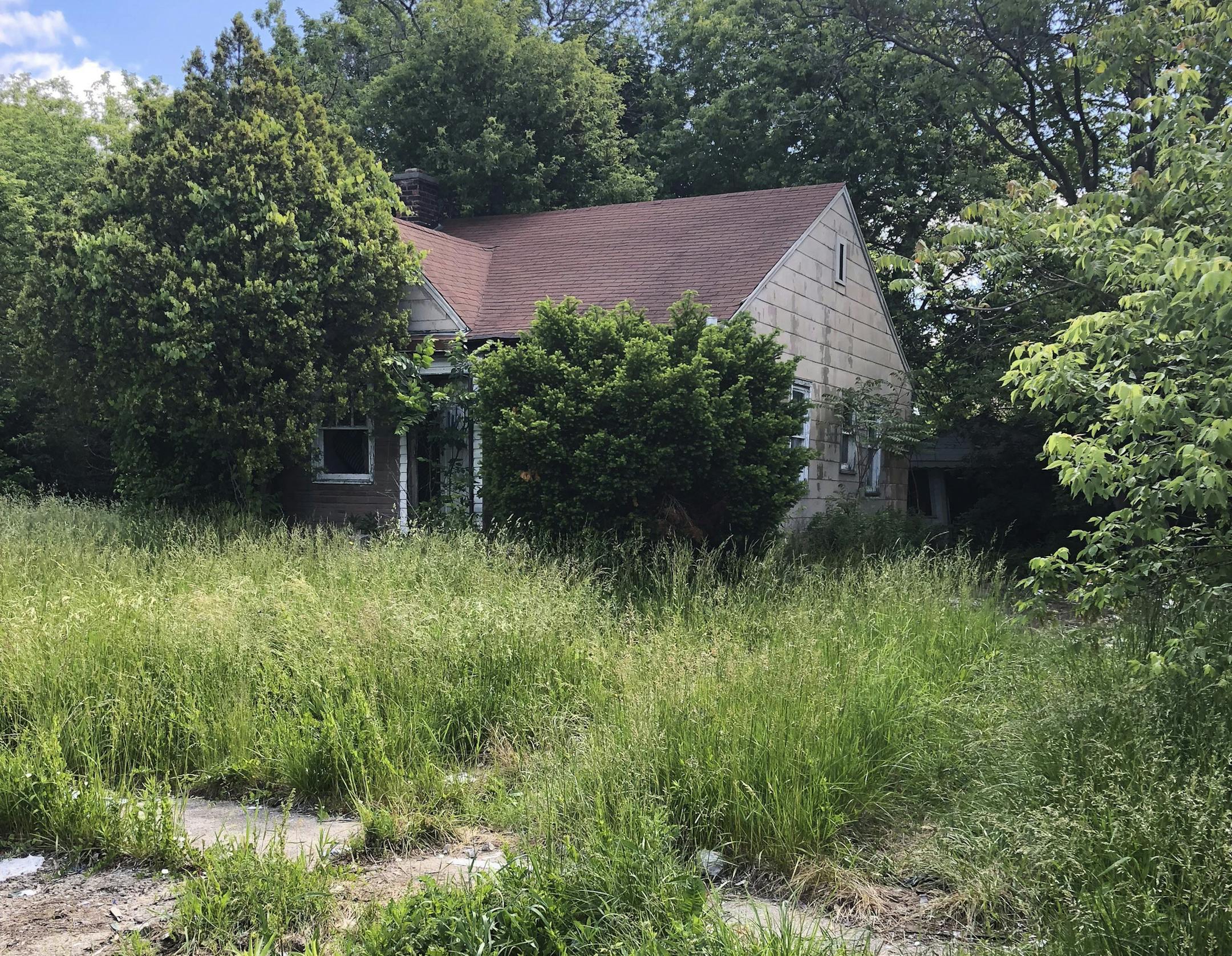 This June 6, 2018 photo, shows a vacant house in Detroit's Brightmoor neighborhood. The city has demolished thousands of vacant houses five years after filing the largest municipal bankruptcy in U.S. history, but some residents say more can be done to improve neighborhoods like Brightmoor. (AP Photo/Corey Williams)