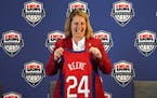Minnesota Lynx head coach Cheryl Reeve stands for photos with her ceremonial jersey during a press conference to announce she'd been named the head co