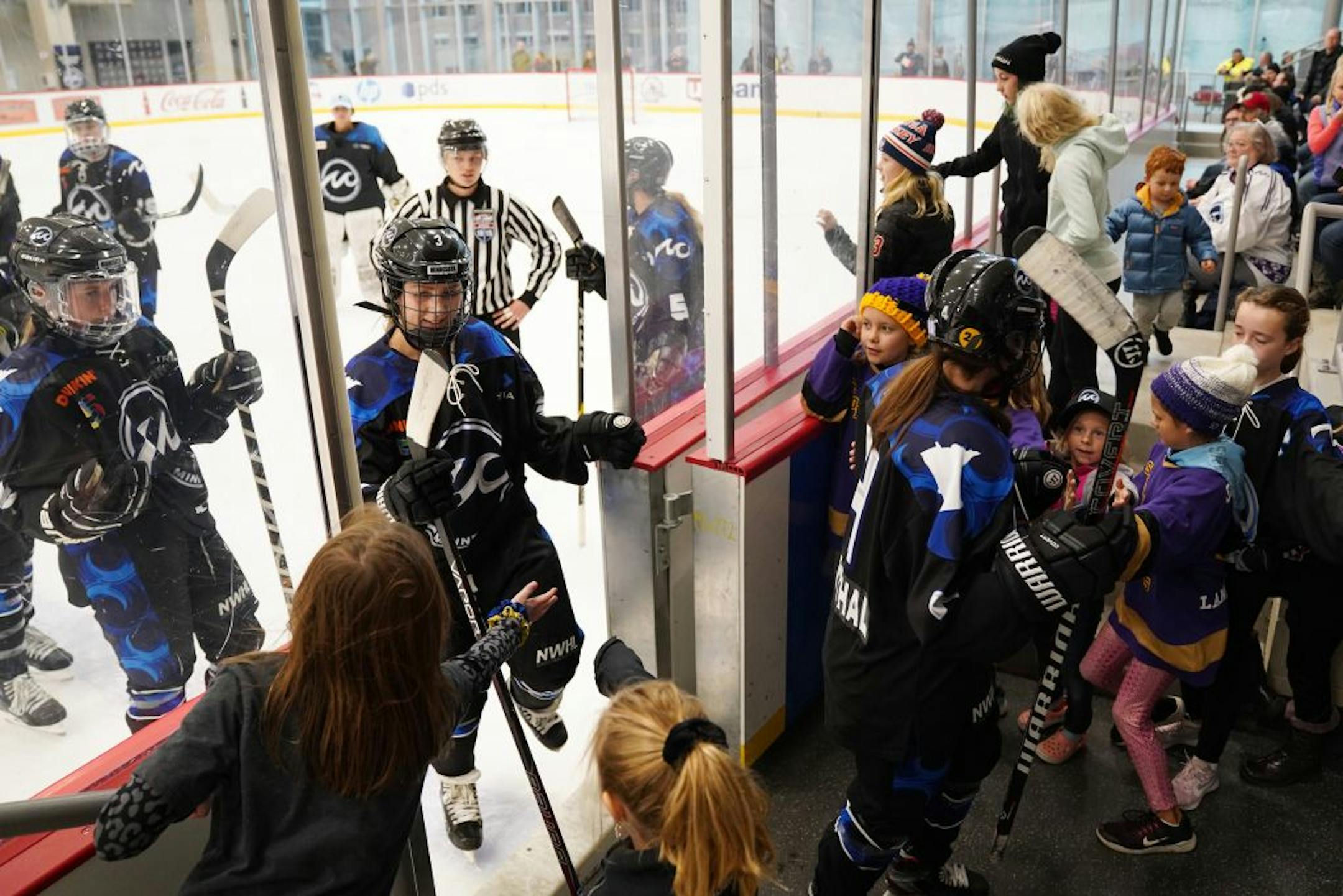 Whitecaps players were greeted by young fans as they headed from the ice to the locker room between periods during Saturday's game.