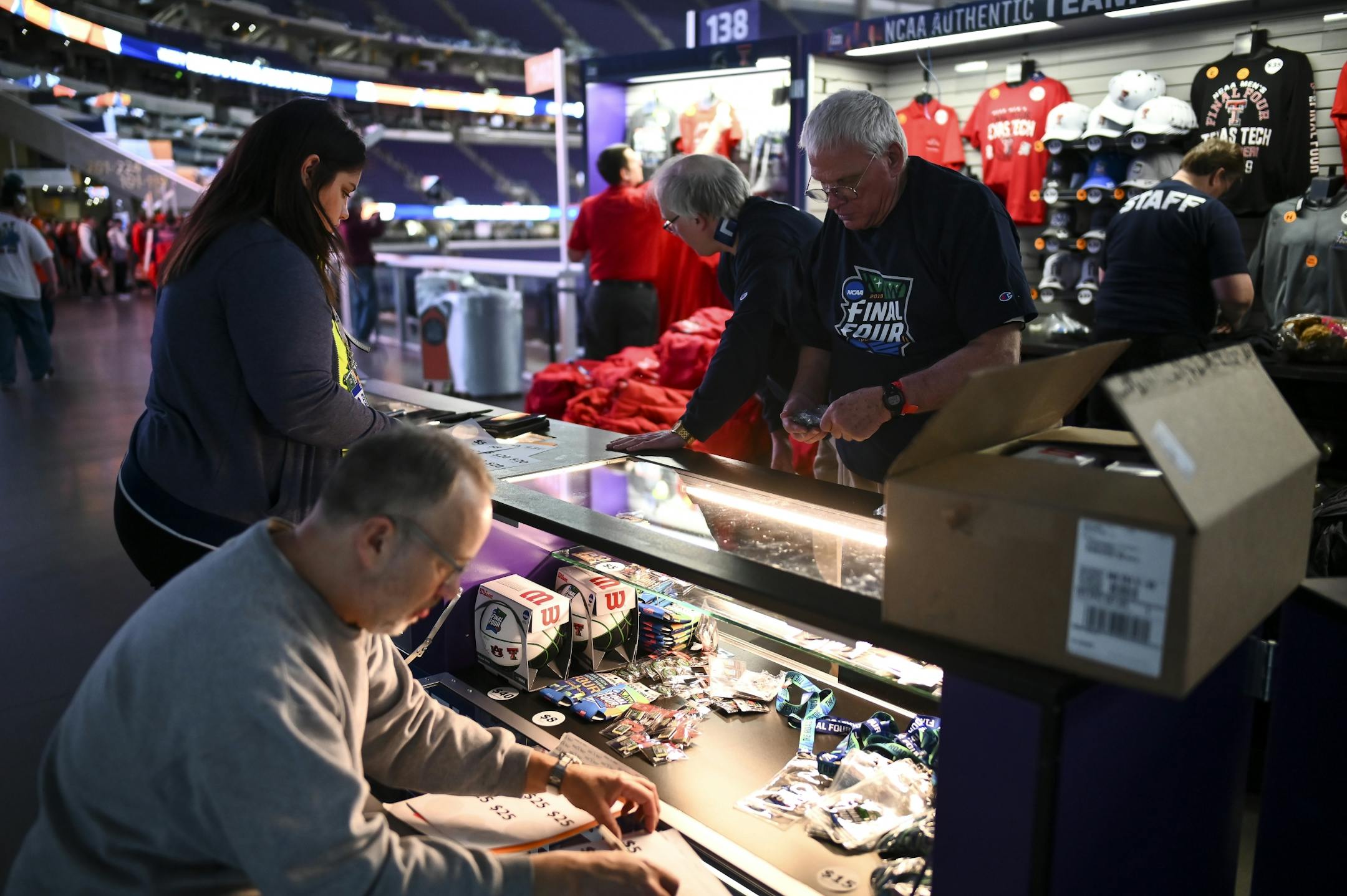 Vendors rushed to set up their sale display as fans began trickling into U.S. Bank Stadium Friday.